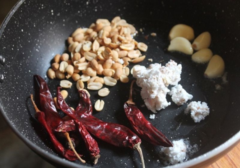 for making tomato peanut chutney, roast peanuts, coconut, chillies and garlic