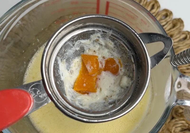 orange peel and cardamom skins strained in sieve