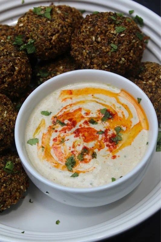 tahini sauce served with falafels with a drizzle of olive oil