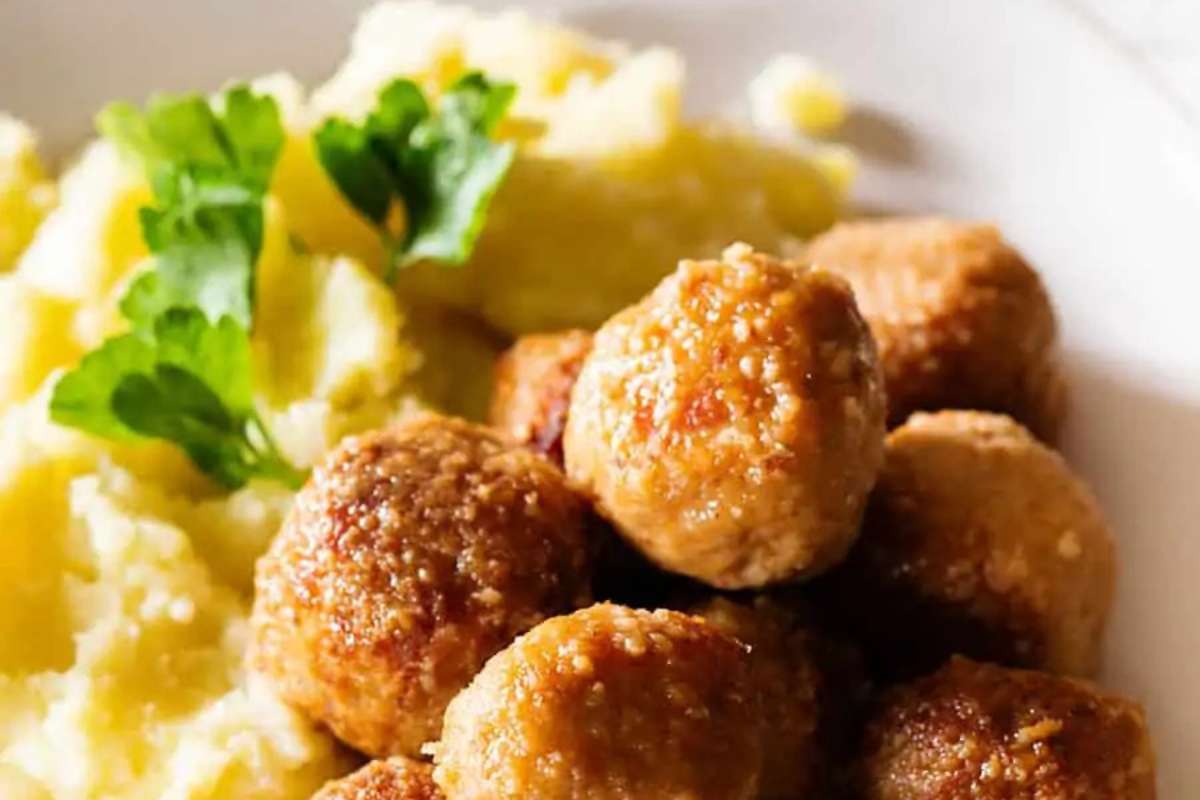 Italian meatballs on a plate with mashed potatoes.