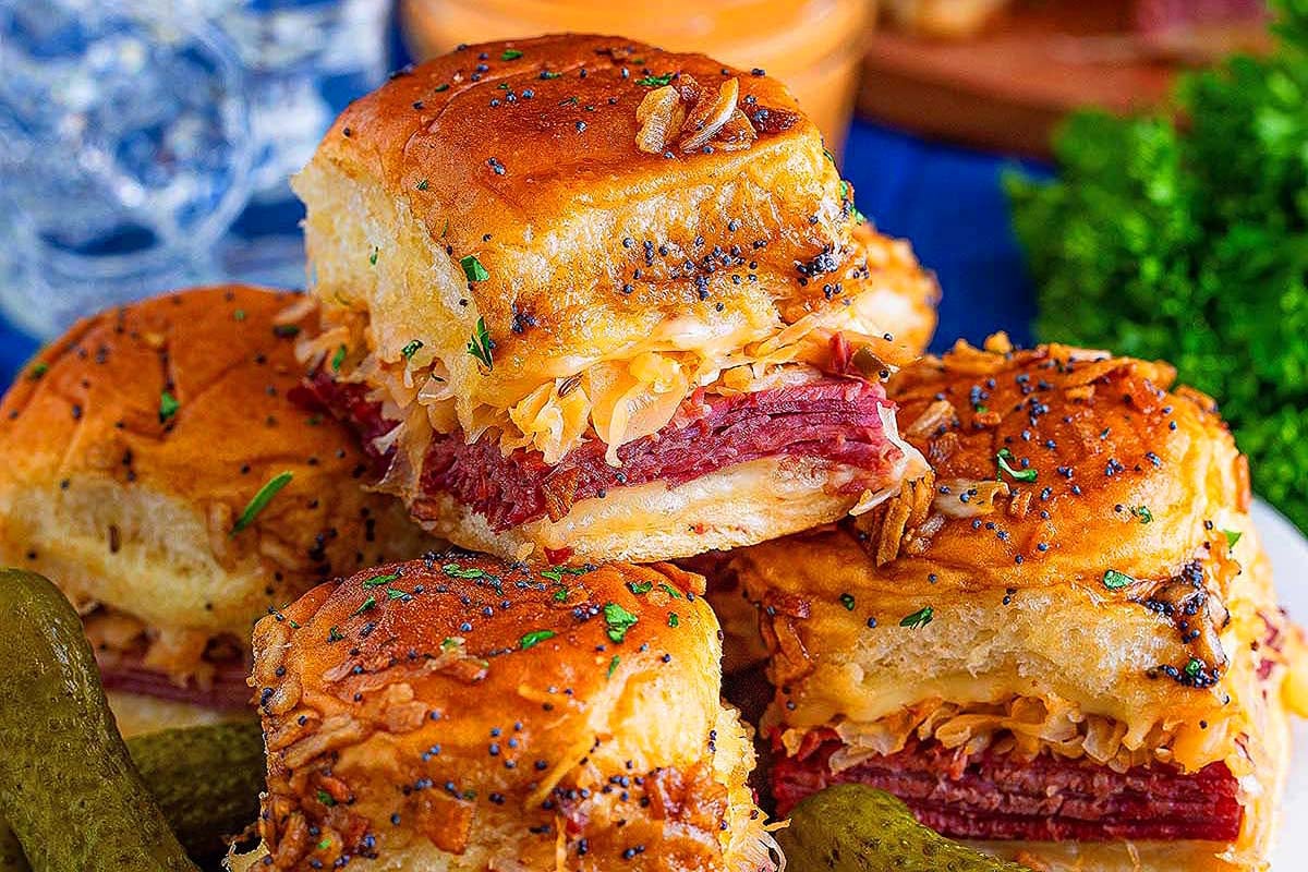 A plate of sliders with pickles on it, made using savory slider recipes.