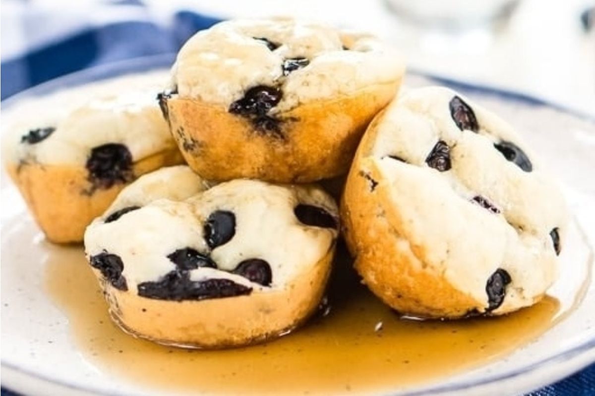 A plate of muffins made with Bisquick recipes with blueberries on it.