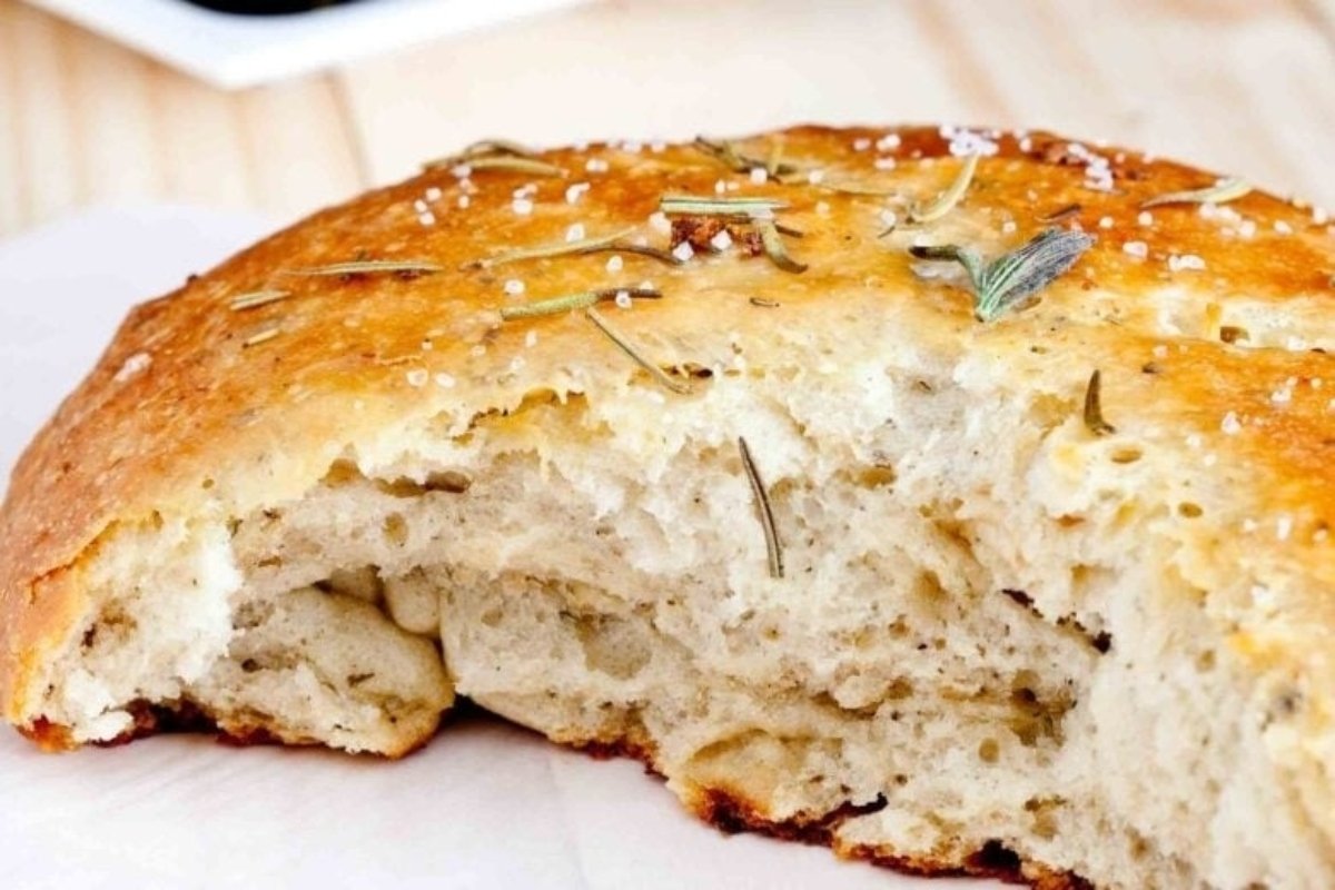 A loaf of bread with rosemary on top from our bread recipes.